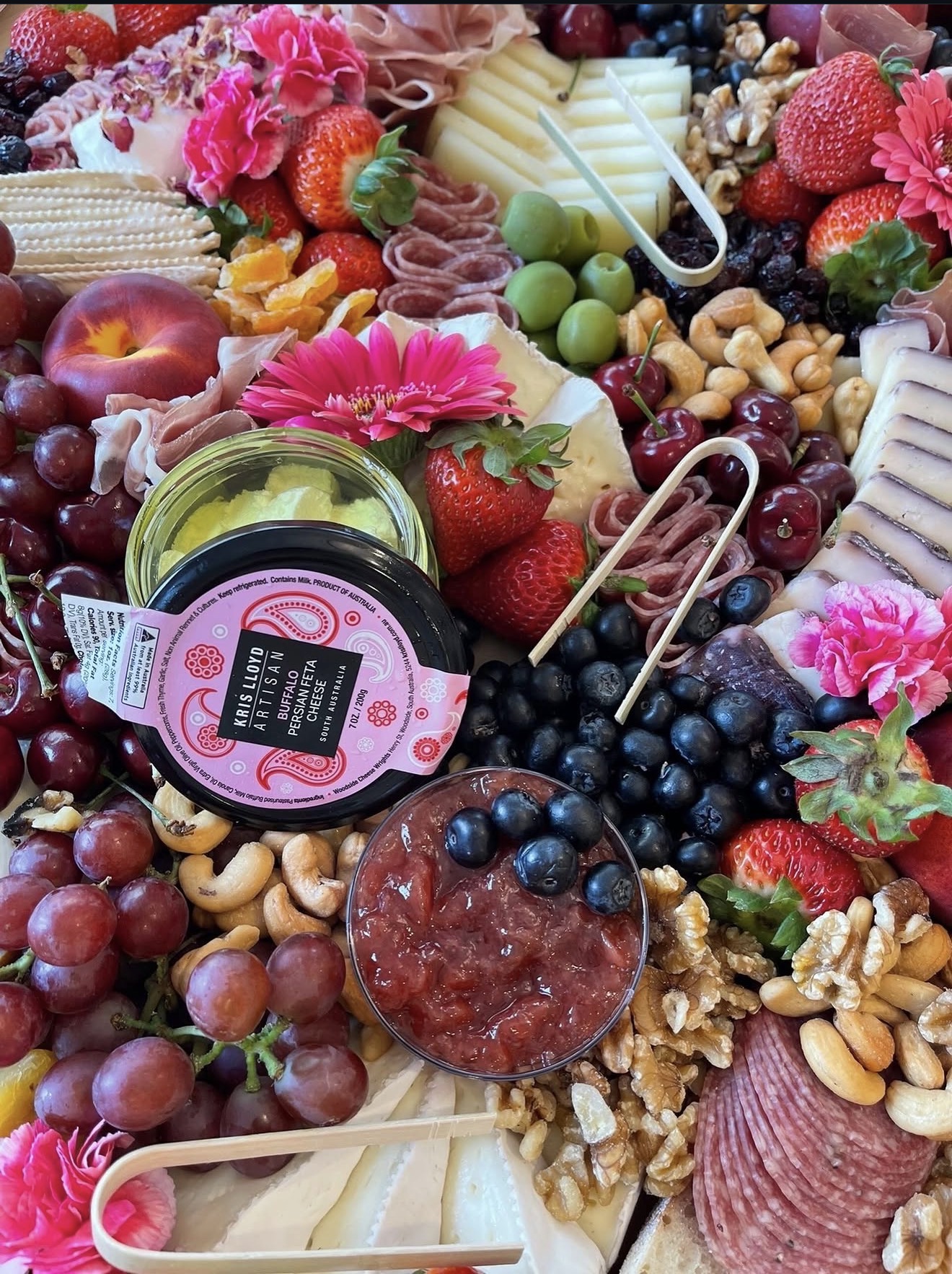 Lavish charcuterie spread with cheeses, prosciutto, and fresh fruit